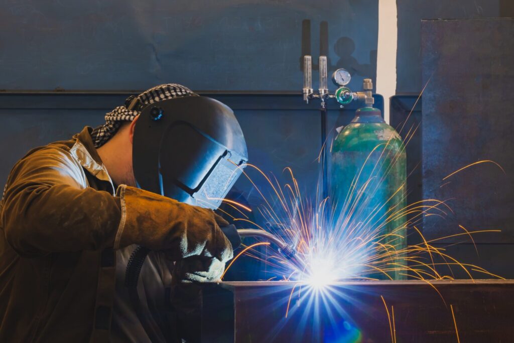 A welder performing MIG welding.